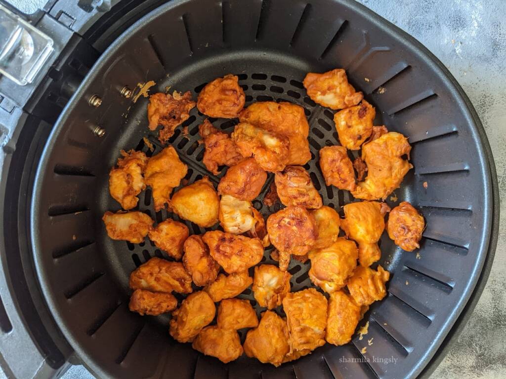 5. After 8 mins open the air fryer and flip the chicken. Brush with little oil and then air fry for another 8 mins. If you do not have an air fryer you may deep fry the chicken.