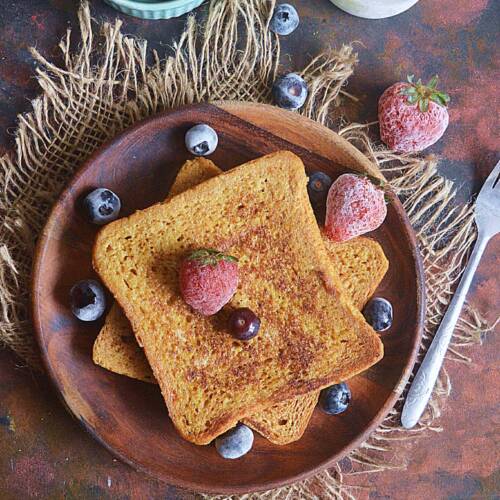 Classic French Toast with Egg and Milk topped with berries.
